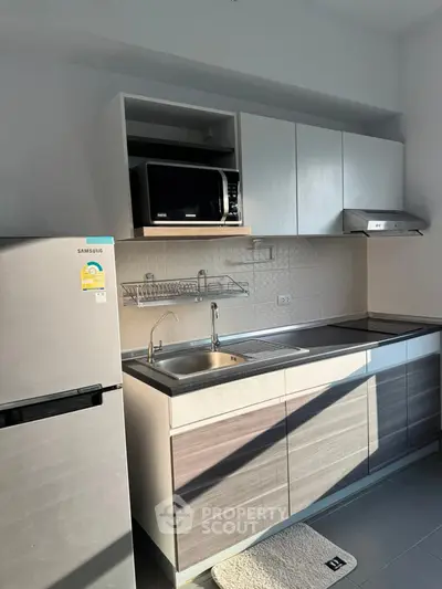 Modern kitchen with sleek cabinets, stainless steel appliances, and ample natural light.