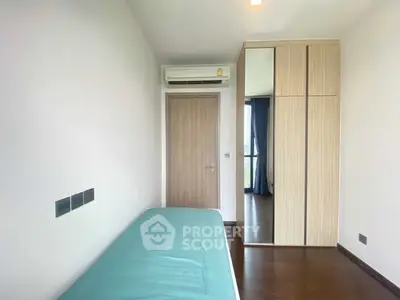 Modern minimalist bedroom with air conditioning and wooden wardrobe