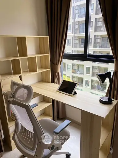Modern study room with ergonomic chair and tablet, overlooking urban view.