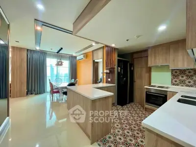 Spacious modern kitchen with open layout and stylish dining area, featuring sleek cabinetry and patterned tile flooring.