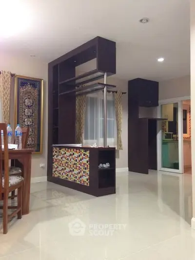 Spacious modern living area with unique partition and elegant decor