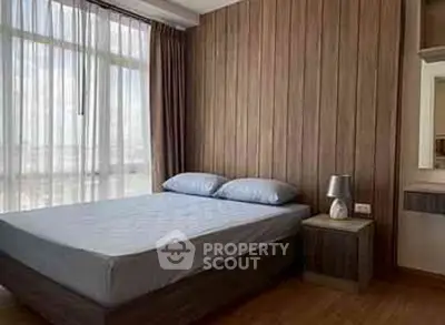 Modern bedroom with large window and stylish wooden paneling