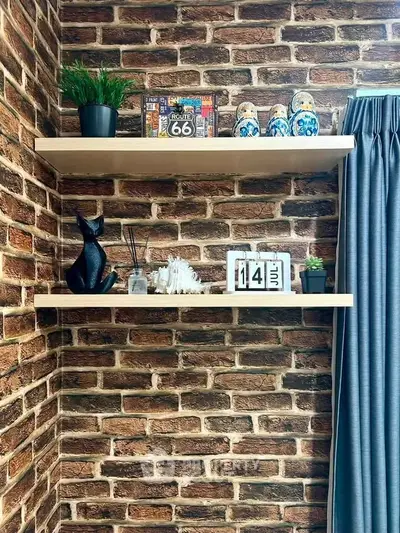 Stylish brick wall with floating shelves and decor in modern living room corner.
