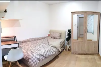 Cozy bedroom with modern furniture and wooden flooring, perfect for a comfortable living experience.