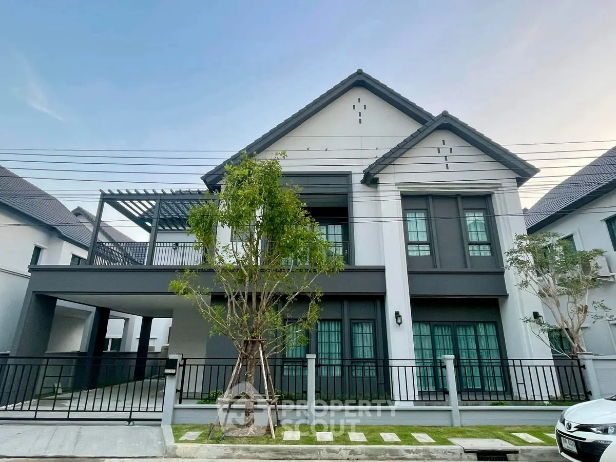 Modern two-story house with spacious balcony and sleek exterior design