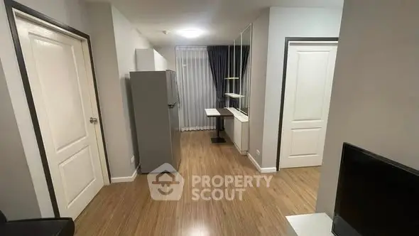 Modern apartment interior with sleek wooden flooring and minimalist design.