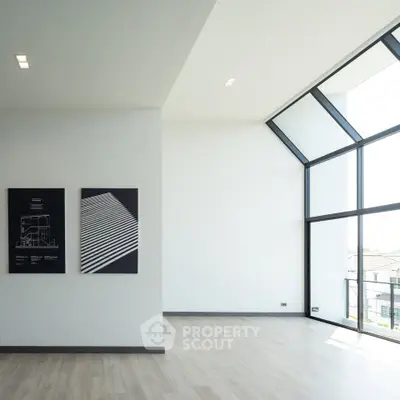 Spacious modern living room with large windows and minimalist decor