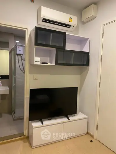 Modern living room with sleek TV unit and air conditioning