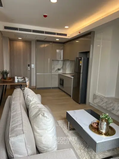 Modern open-layout living room with sleek kitchen and stylish decor