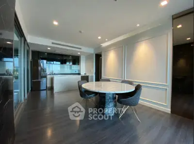 Elegant modern dining area with marble table and sleek kitchen design