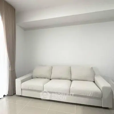 Spacious minimalist living room with elegant white sofa and natural light