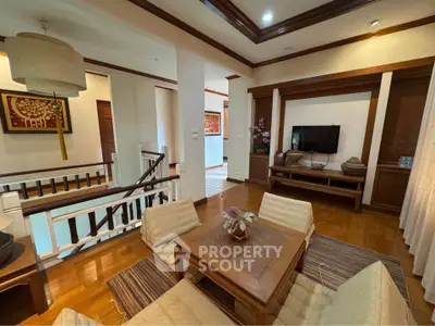 Charming living room with wooden flooring and cozy seating area, perfect for relaxation and entertainment.