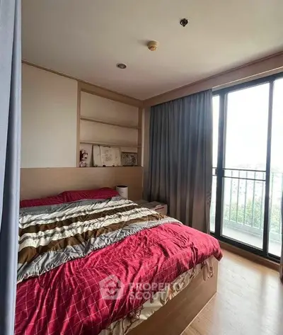 Cozy bedroom with large window and balcony access in modern apartment