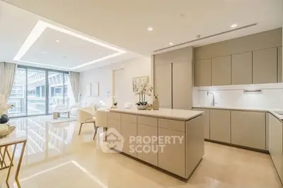 Luxurious open-plan kitchen and living area with modern design and ample natural light.