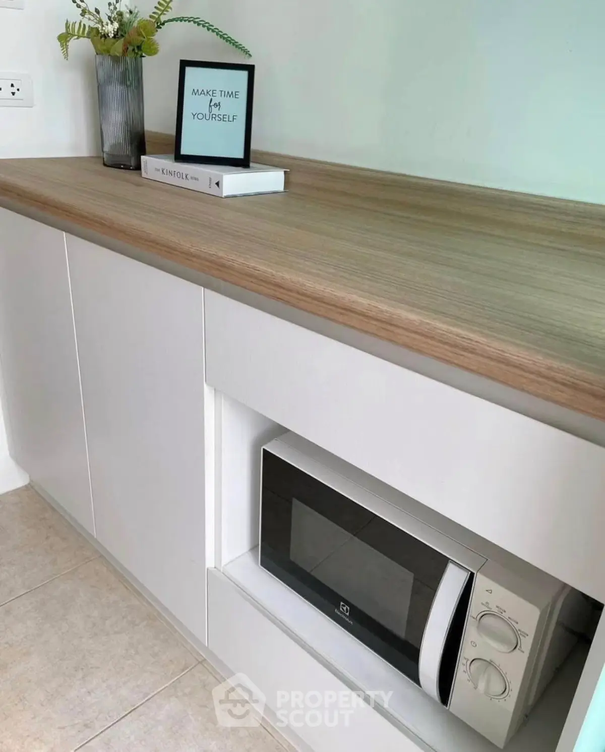 Modern kitchen with built-in microwave and stylish wooden countertop