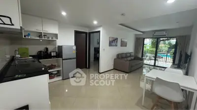 Modern open-layout living room with kitchen and balcony view