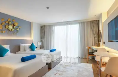 Modern twin bedroom with stylish decor and natural light