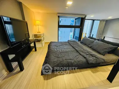 Modern bedroom with large window and stylish decor in urban apartment