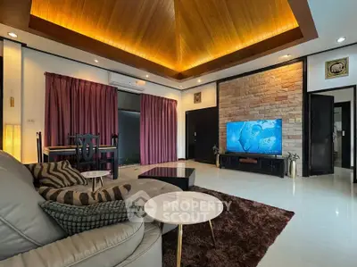 Luxurious living room with modern decor, high ceiling, and elegant lighting