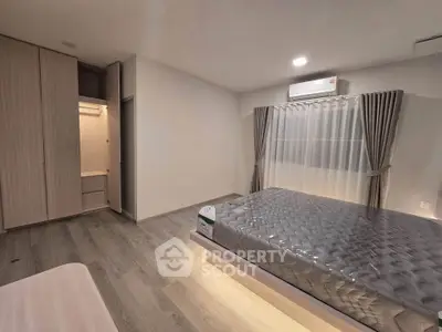 Spacious modern bedroom with sleek design and ample natural light
