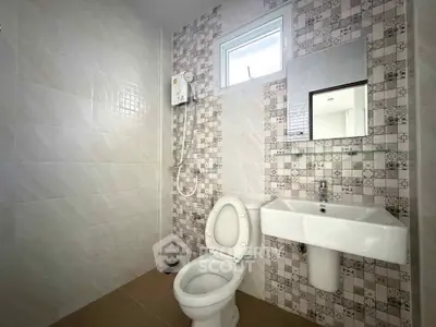 Modern bathroom with stylish tiles and compact fixtures