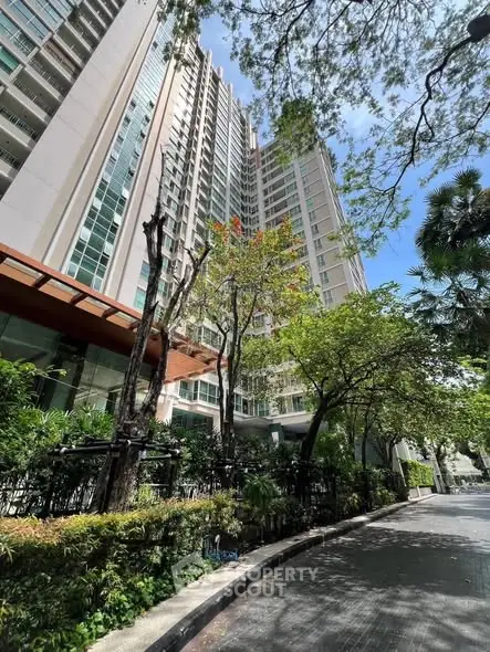 Stunning high-rise building with lush greenery and modern architecture in urban setting.