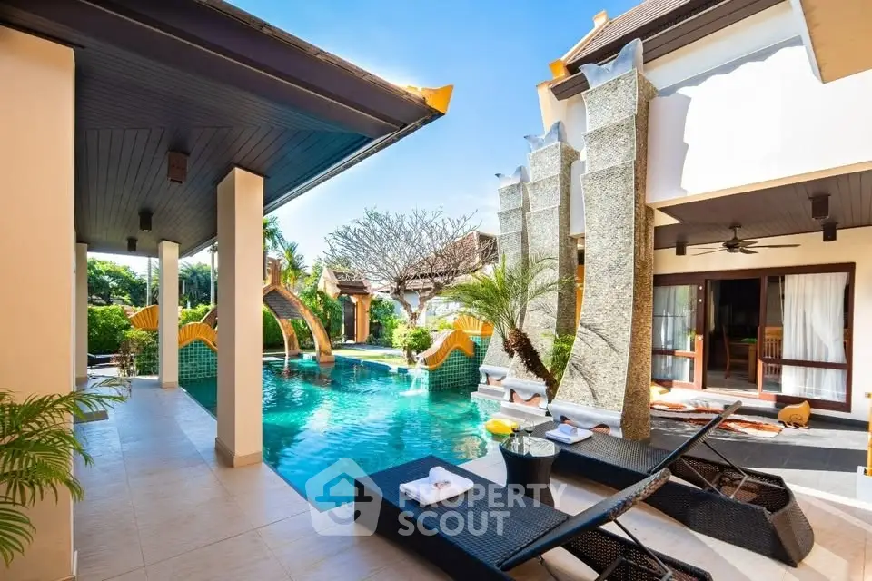 Luxurious villa with private pool and sun loungers in tropical setting