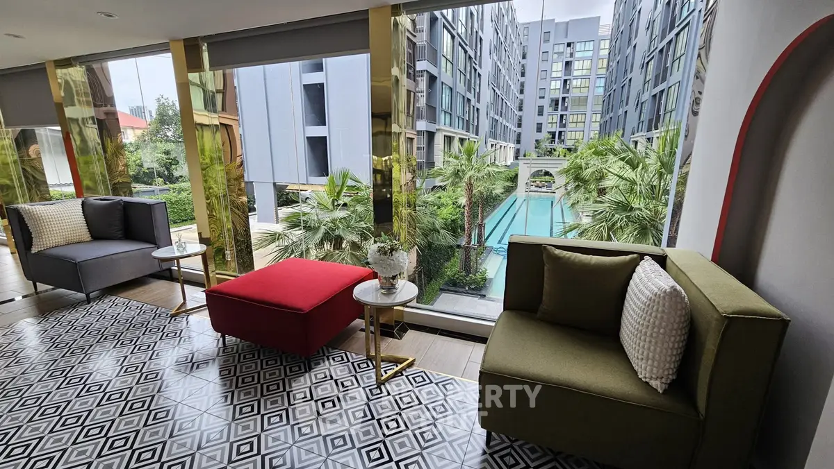 Luxurious condo lounge with pool view, modern seating, and stylish decor.