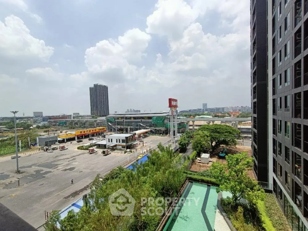 Stunning urban view from high-rise building with lush greenery and cityscape.