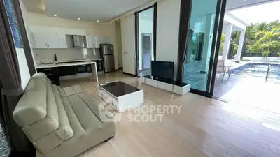 Modern living room with pool view and open kitchen layout