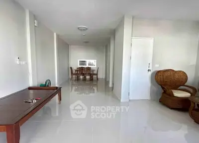 Spacious living area with elegant furniture and glossy tiled flooring