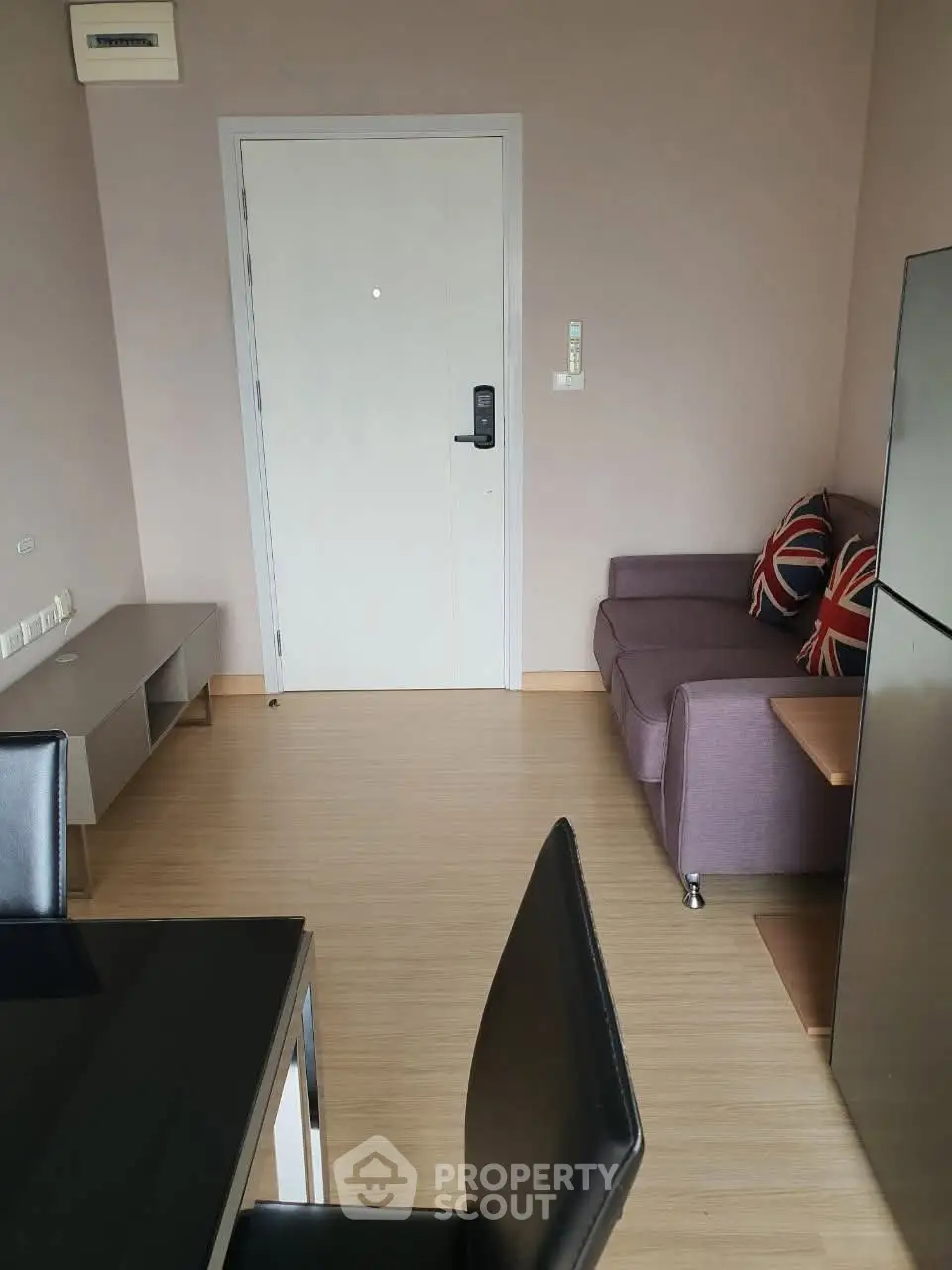 Modern apartment interior with cozy living area and dining space, featuring stylish furniture and sleek design.