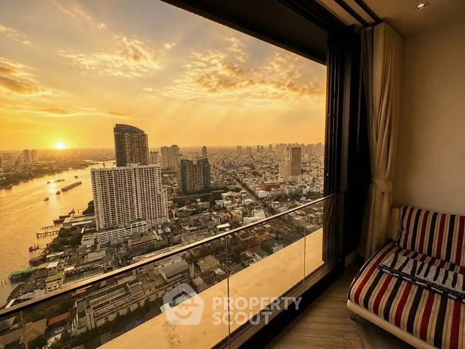 Stunning cityscape view from a high-rise balcony at sunset, featuring a cozy seating area.