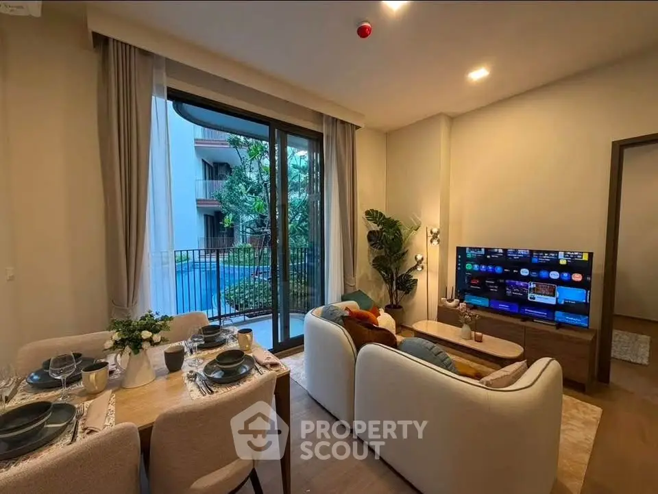 Modern living room with pool view, stylish furniture, and dining area in a luxury apartment.