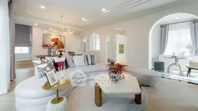 Luxurious living room with modern decor and elegant lighting, featuring a spacious open layout and stylish furniture.