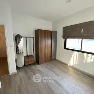 Spacious bedroom with modern wardrobe and natural light