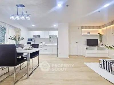 Modern open-layout kitchen and dining area with sleek design and ample natural light.