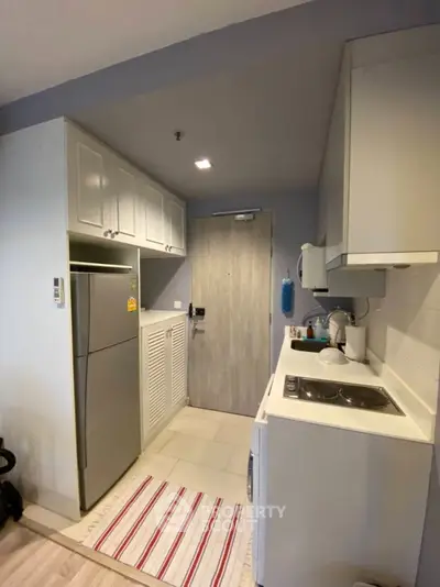 Compact modern kitchen with sleek cabinets and appliances in cozy apartment