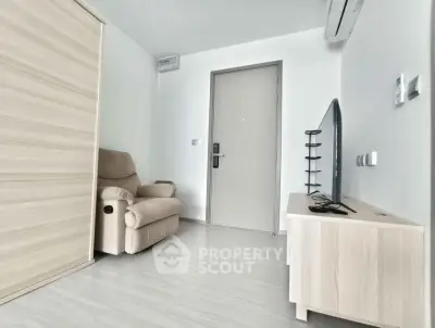 Modern minimalist living room with beige recliner and sleek TV setup