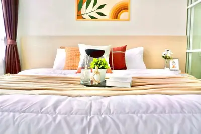 Cozy bedroom with stylish decor and plush bedding