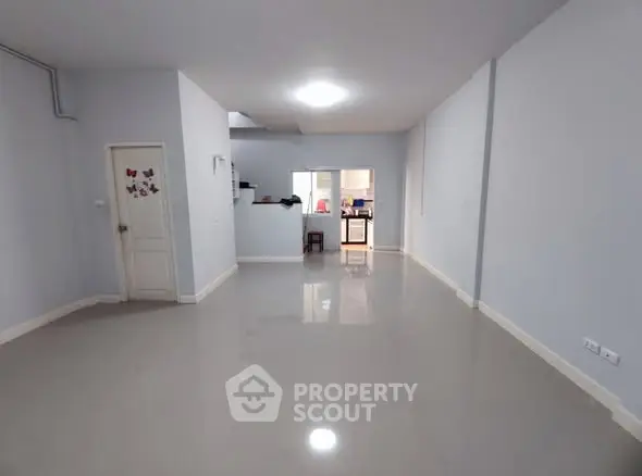 Spacious open-plan living area with sleek flooring and modern design