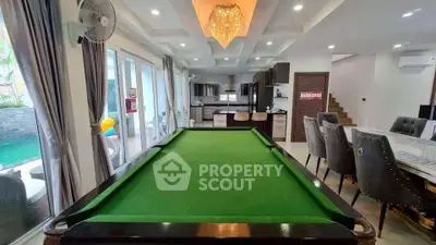 Luxurious open-plan living area with pool table and modern kitchen