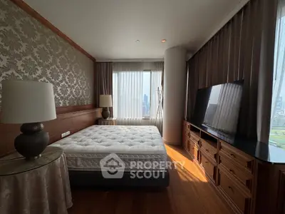 Luxurious bedroom with elegant decor and stunning city view, featuring a plush mattress and stylish furnishings.