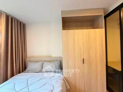 Cozy bedroom with modern wardrobe and soft lighting, perfect for relaxation.
