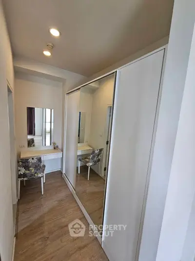 Stylish bedroom with mirrored wardrobe and elegant vanity setup