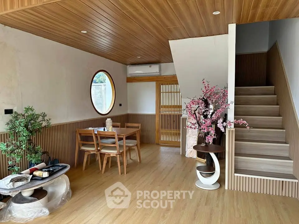 Stylish modern living room with wooden accents and elegant staircase