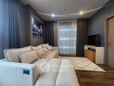 Modern living room with cozy beige sofa and stylish decor in a contemporary apartment.