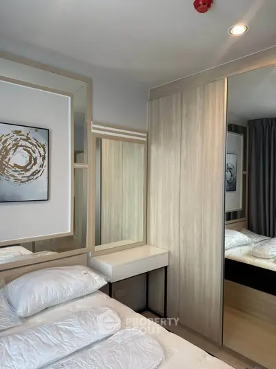 Modern bedroom with stylish wooden wardrobe and elegant decor