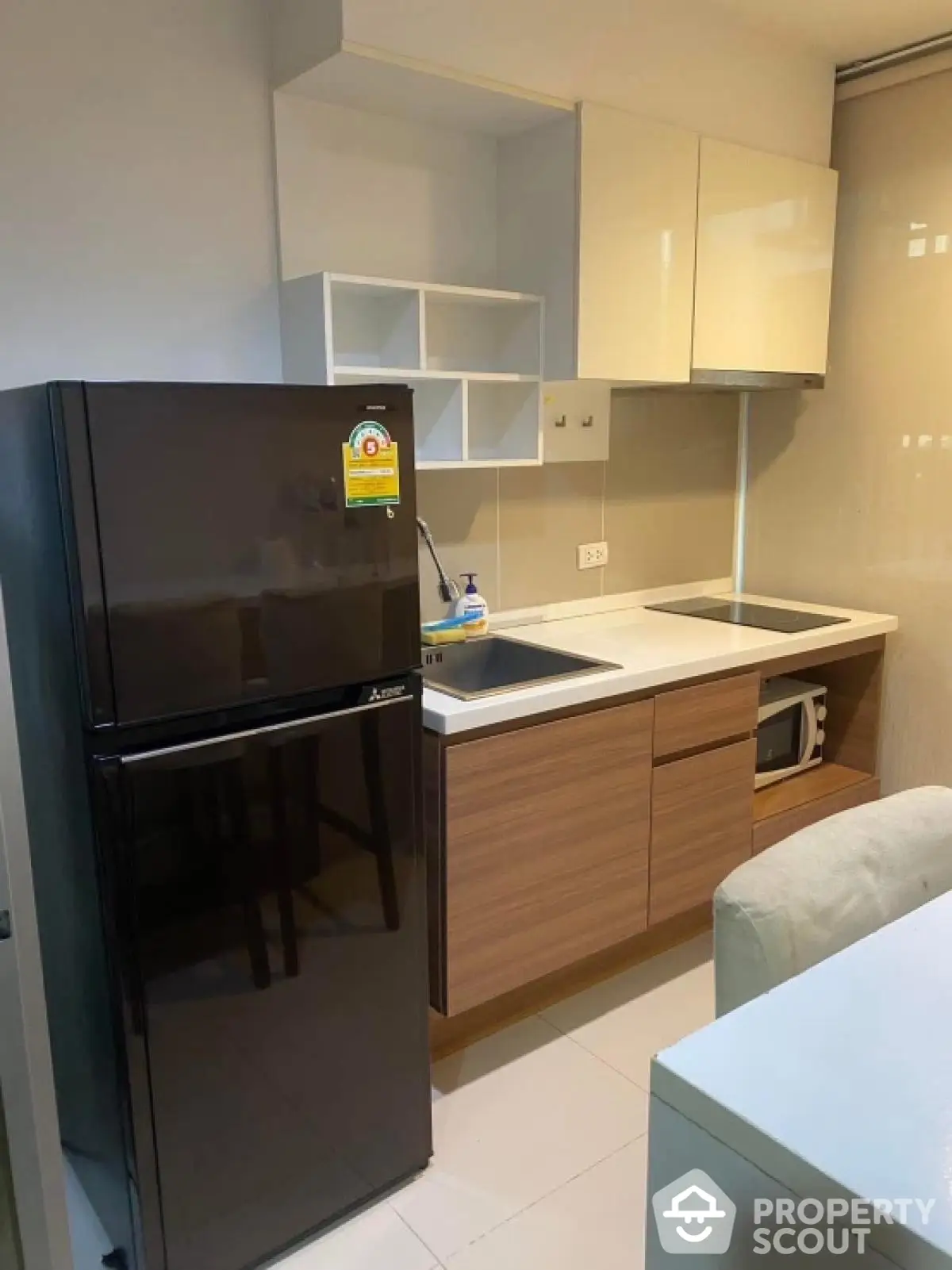 Modern kitchen with sleek cabinets and appliances in a stylish apartment