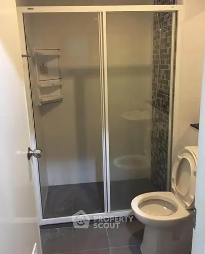 Modern bathroom with glass shower enclosure and sleek tile design